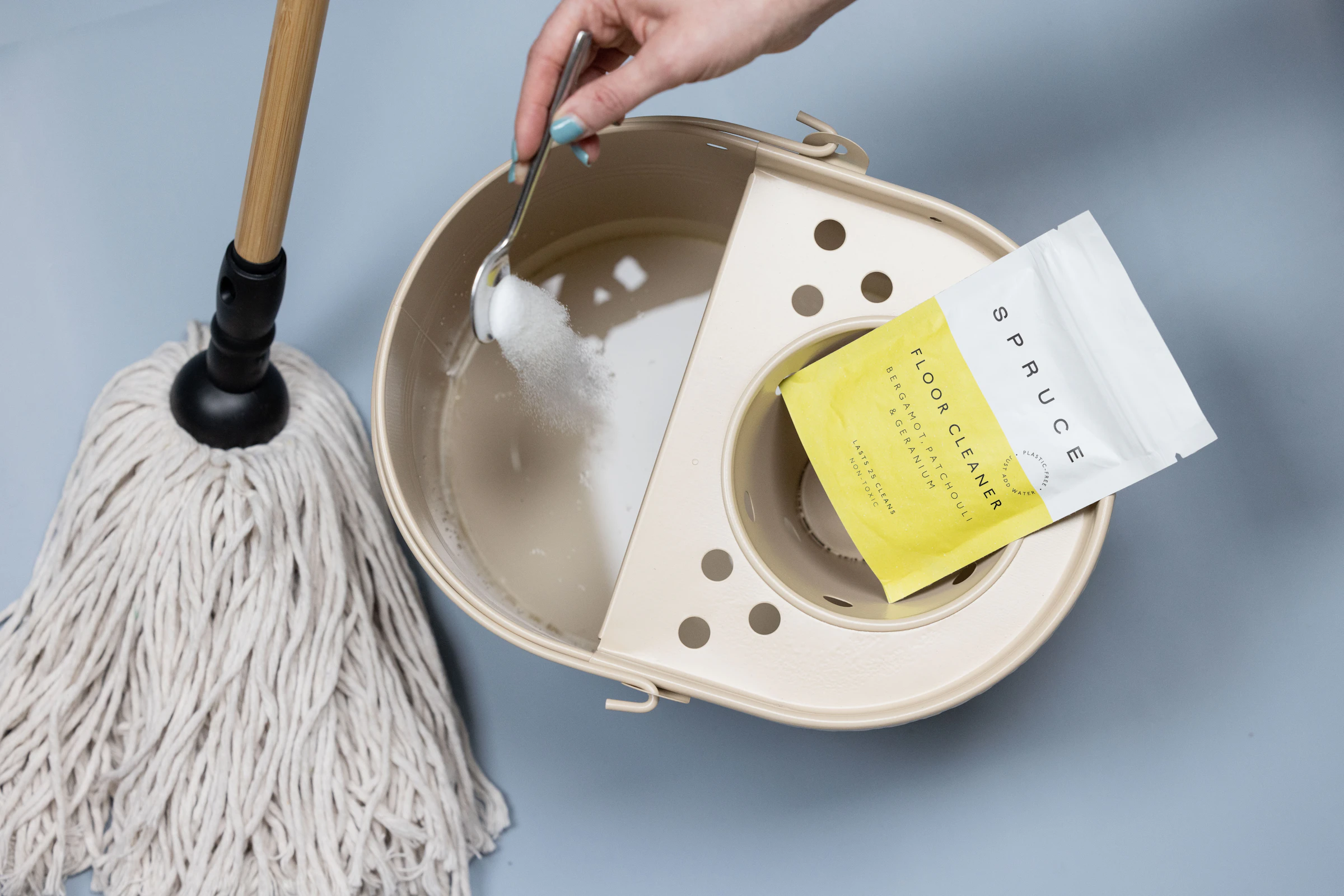 Cleaning powder being added to a mop bucket