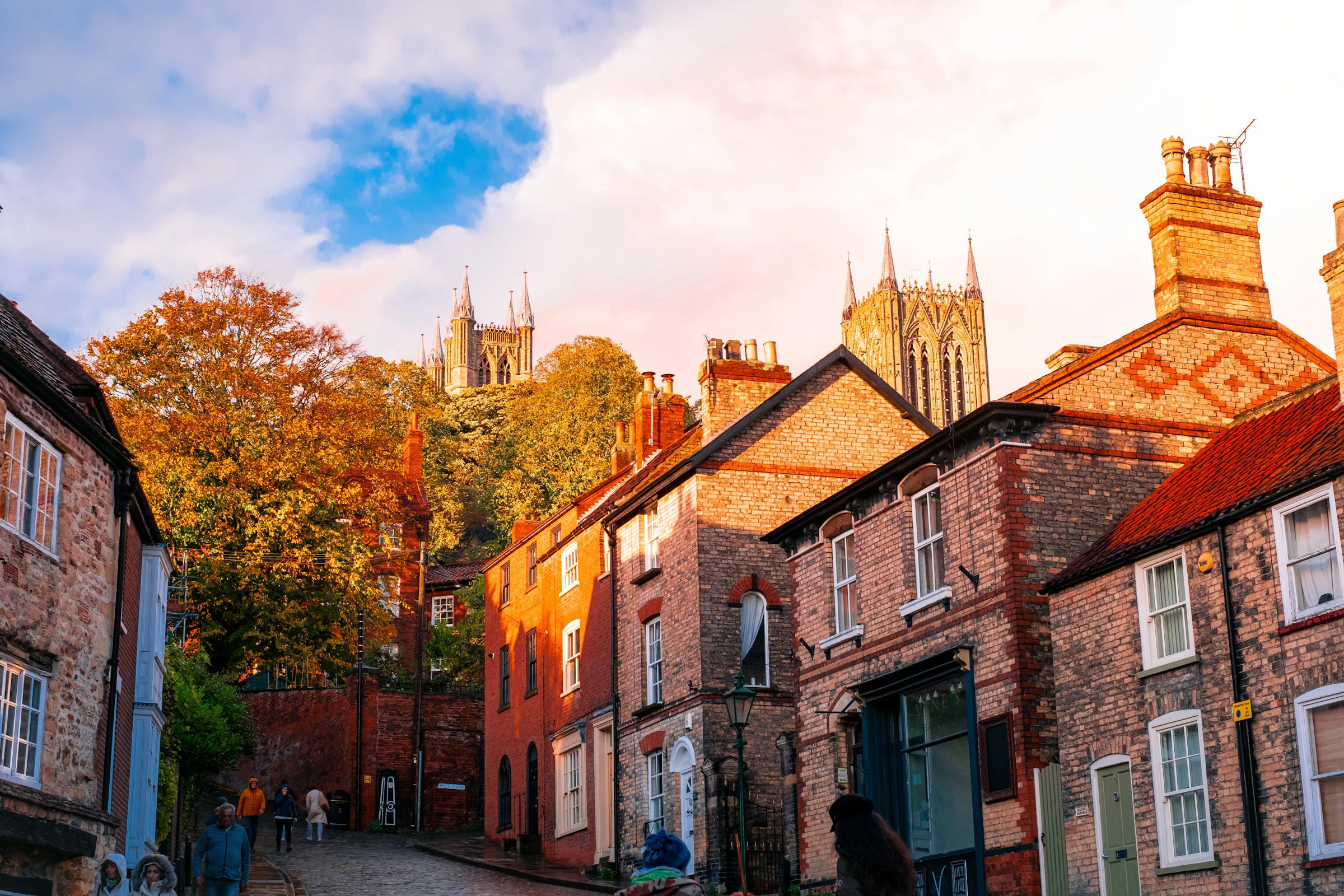 Cobbled street lined with old brick buildings