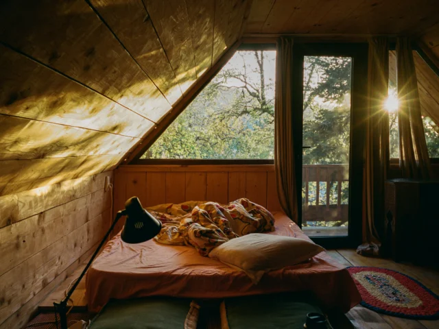 Cosy holiday cottage bedroom with fresh linen in the sunlight
