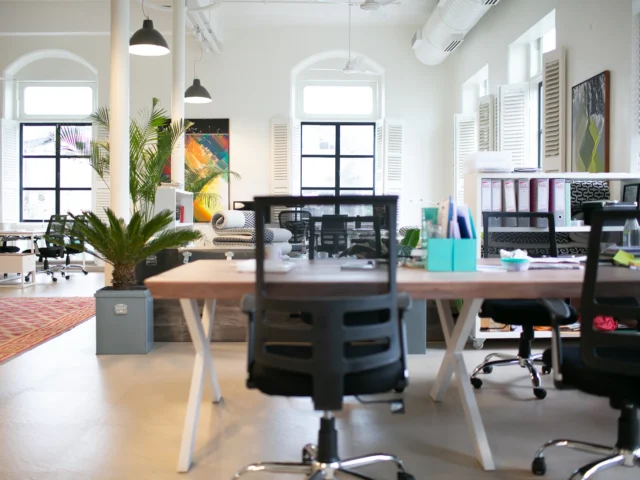 Empty office chairs around a meeting table