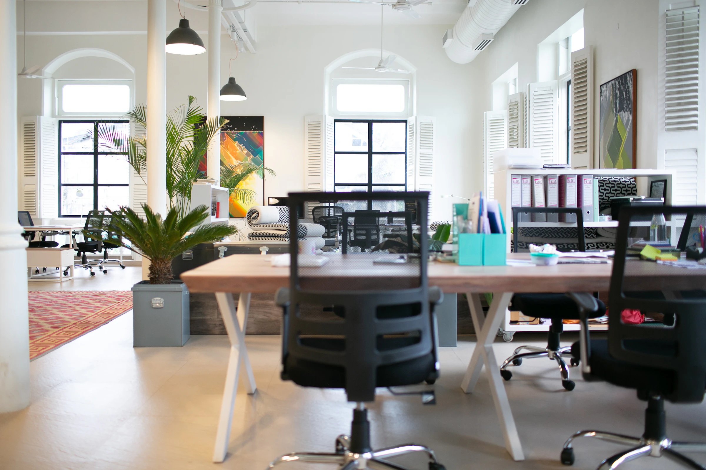 Empty office chairs around a meeting table