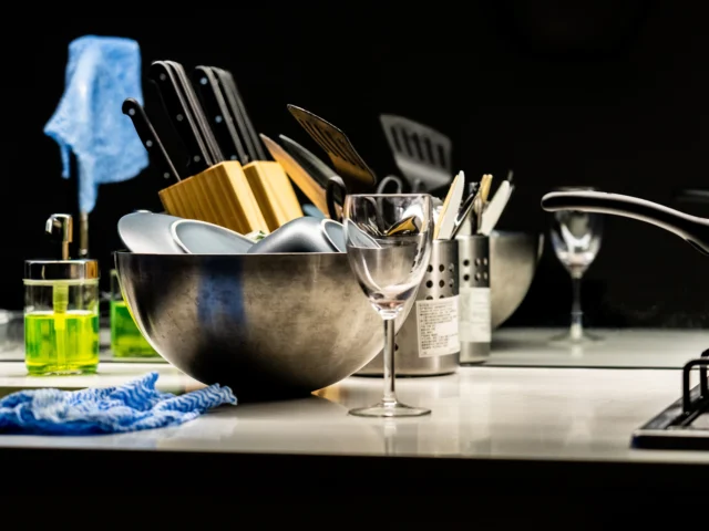 Kitchen sink with dishes and cleaning supplies