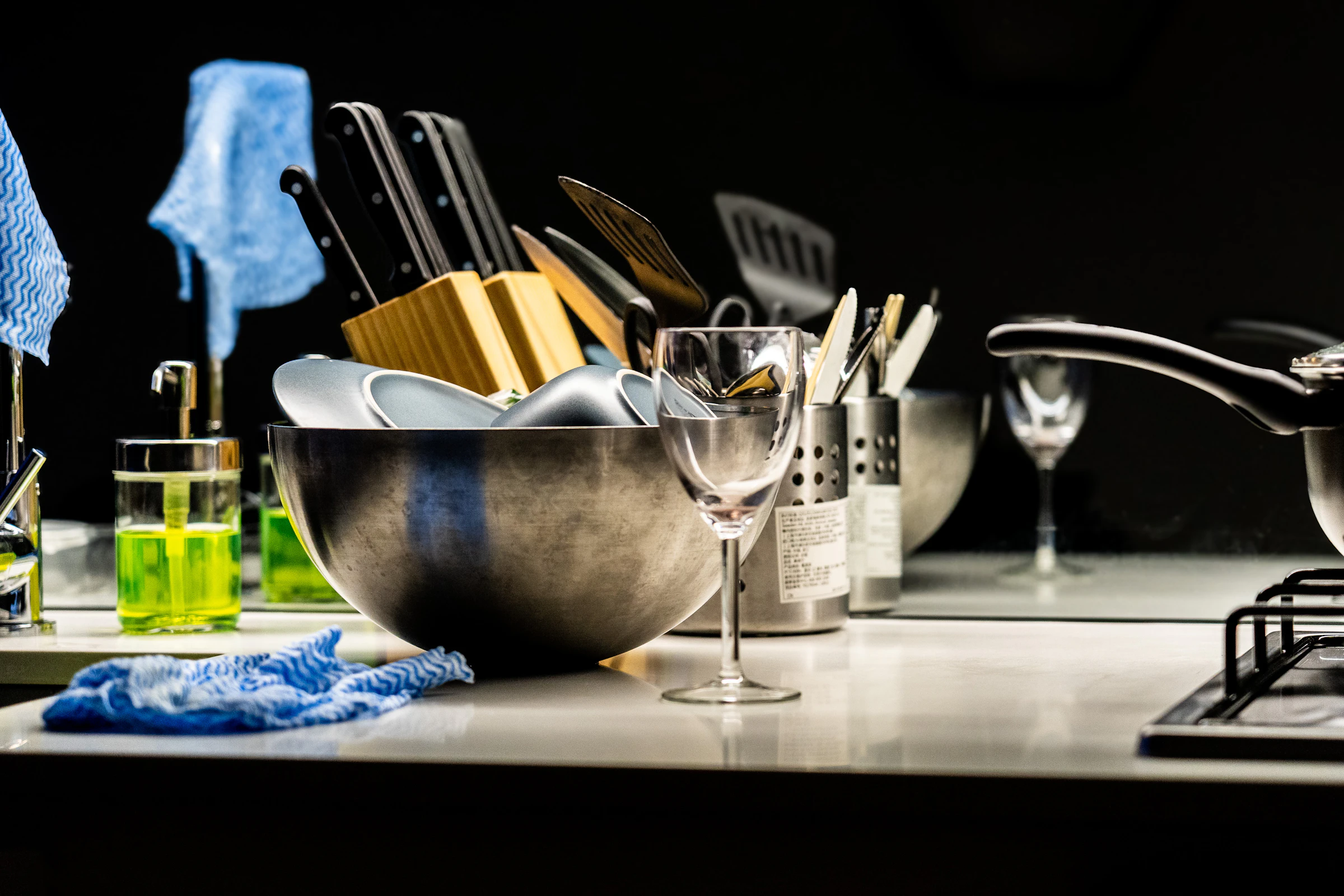 Kitchen sink with dishes and cleaning supplies