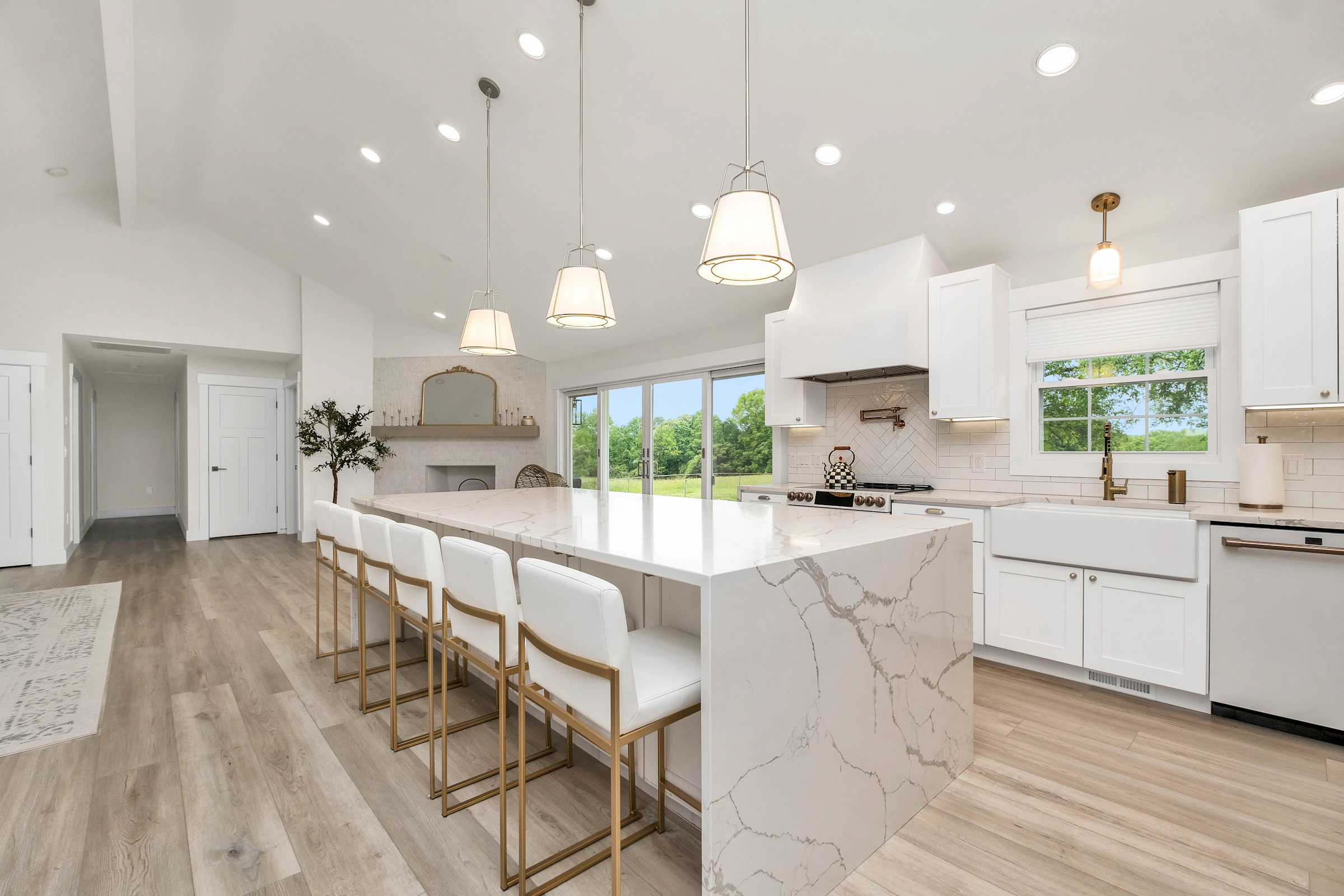 Large kitchen with a marble island and white cabinets