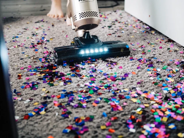 Person vacuuming a carpet