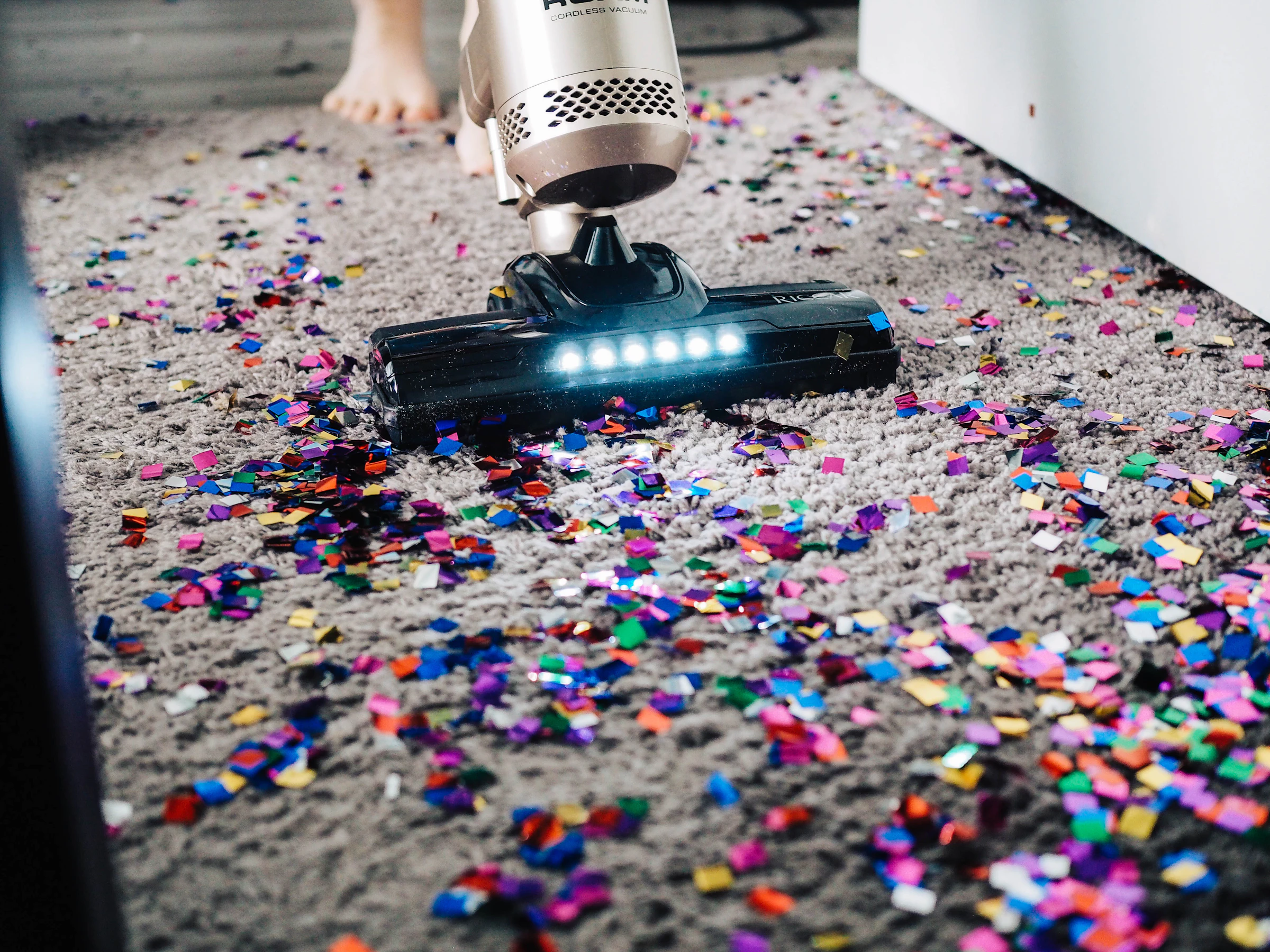 Person vacuuming a carpet