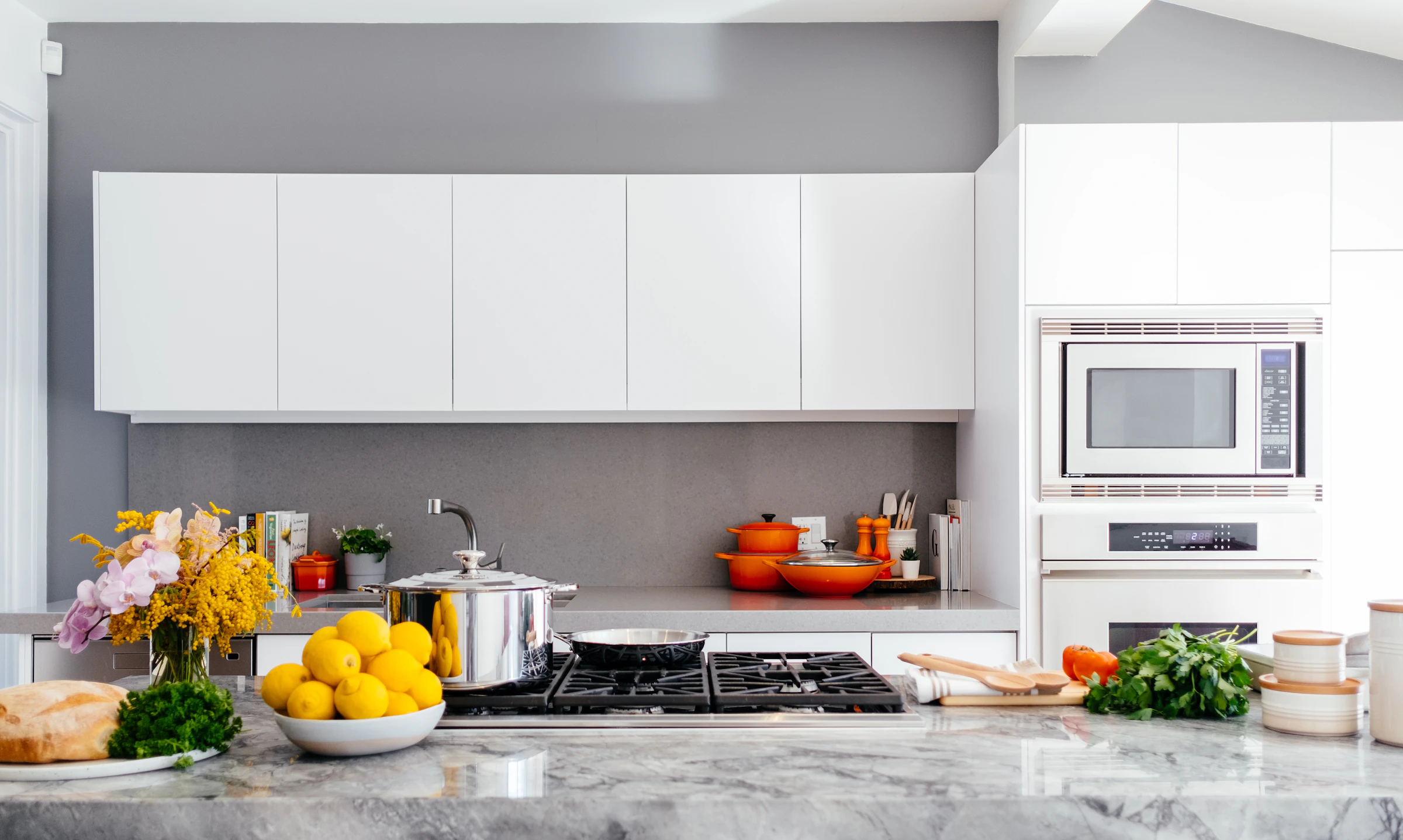 Spotless modern white kitchen with a marble island