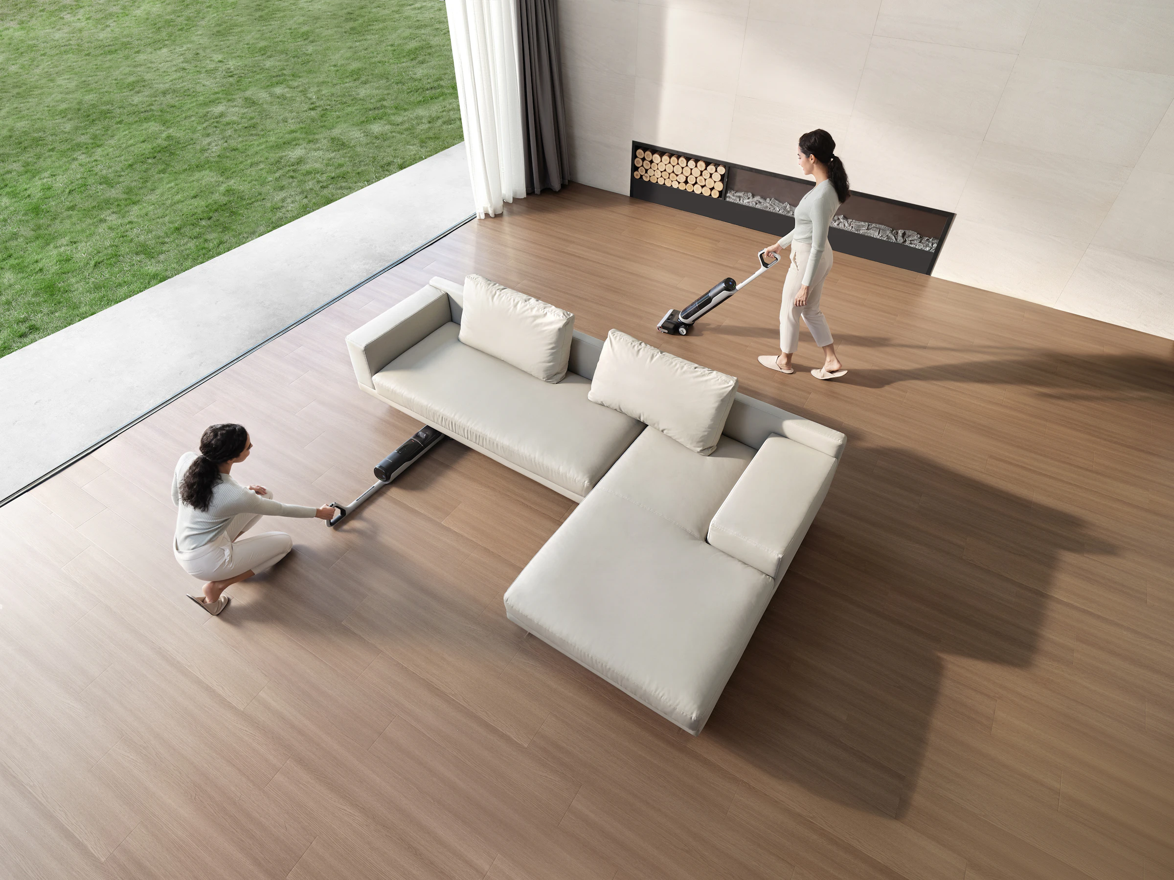 Two cleaners working together in a living room