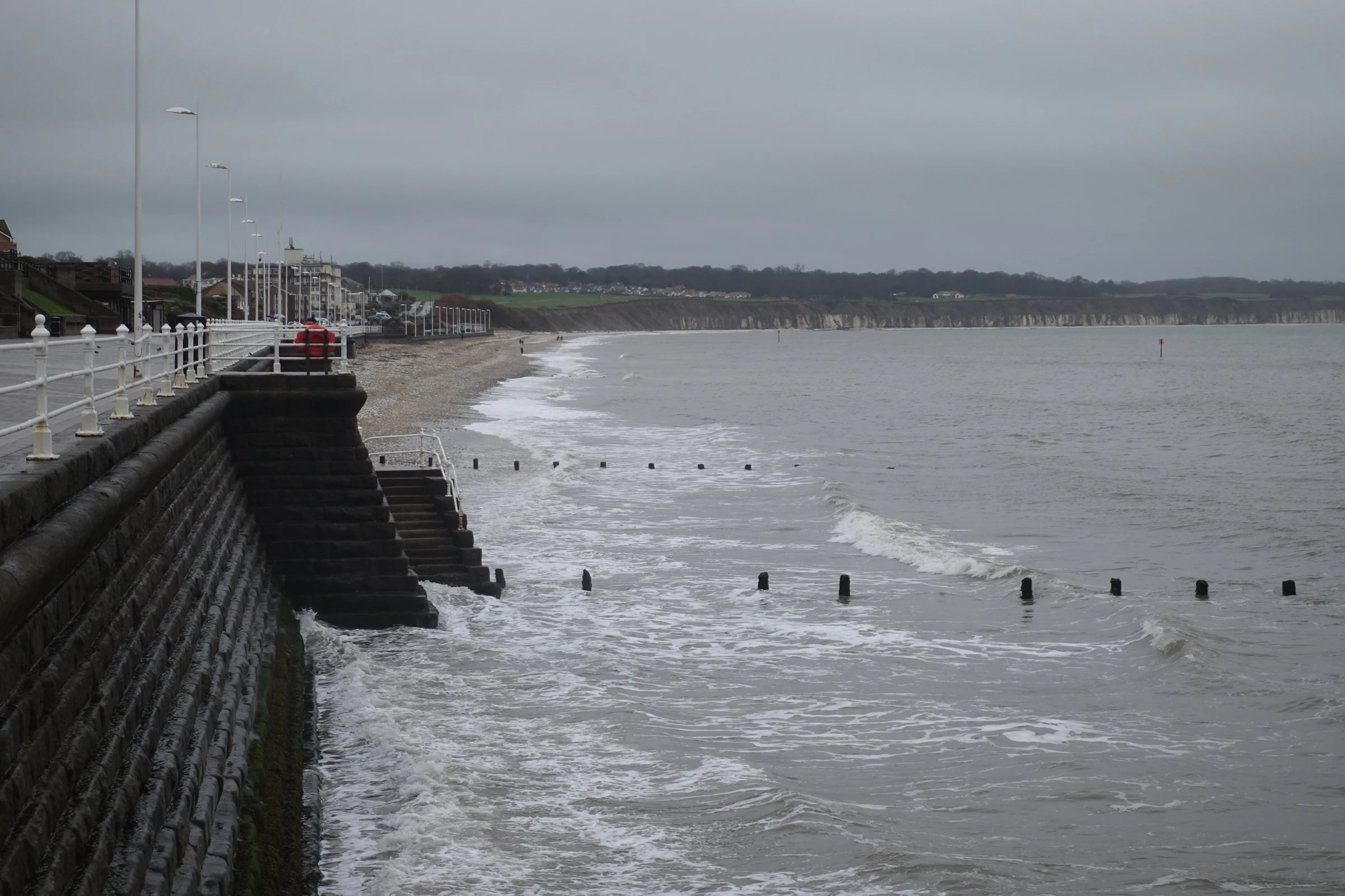 Waves breaking against a sea wall on the East Yorkshire coast